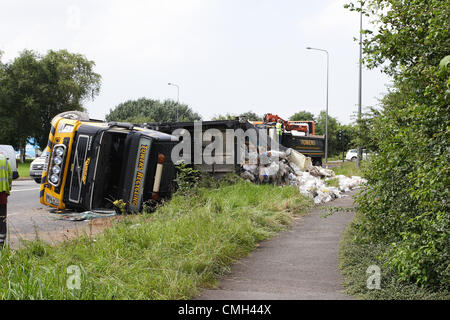 9th Aug 2012. A heavy truck owned by the Weston super Mare based Towens Recycling truned over on its side while travelling on A4174 round the Wick roundabout near the Willy Wicket pub. It was carrying waste for recycling. Credit:  Timothy Large / Alamy Live News Stock Photo
