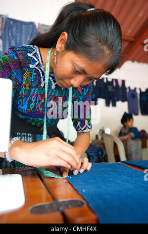 Aug. 2, 2012 - Santa Catarina Polopo (Municipal, Solola (Department, Guatemala - August 2, 2012, Solola, Guatemala - A young woman learns sewing skills at a class supported by Counterpart International in the community of Santa Catarina Palopo, Guatemala. Through partner agency Grupos Gestores (Management Groups), Counterpart helps to pay the salary of the instructor for the four month course, after which participants hope to be able to earn a living by selling clothing and other items to tourists. (Credit Image: © David Snyder/ZUMAPRESS.com) Stock Photo