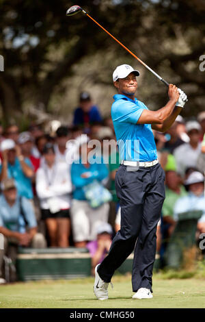 Tiger Woods hits his tee shot on the fifth hole during the first round ...
