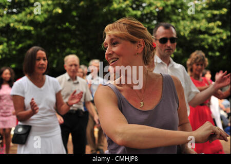 Kele Baker, organiser of the Dance Al Fresco events dancing with other enthusiasts. Two weekends every year enthusiasts of ballroom dancing (Saturdays) and Argentine Tango (sundays) get together to dance on the Broadwalk of Regents Park in aid of trees for the Royal Parks. Organised by Kele Baker who has choreographed many Strictly Come Dancing tango routines, this year it's also the last weekend of the 2012 Games. Stock Photo