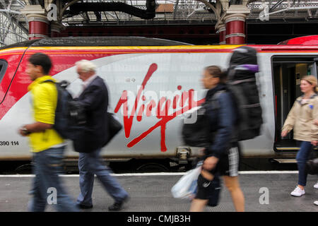 Passengers alighting from a Virgin Train service in Liverpool, UK on Wednesday August 15th 2012. Virgin Trains who currently operate trains to and from London to various main cities on the west coast of the UK, lost the rail franchise to the largest rail company in the UK, First Group, it was announced on August 15, 2012. Virgin Trains have held the franchise to the west coast main line since 1997, and are expected to hand over the franchise to First Group in December 2012. Stock Photo