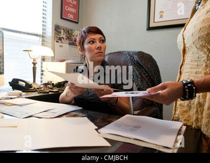 Immigration attorney reviews paperwork regarding Deferred Action for Childhood Arrivals process for client. Stock Photo
