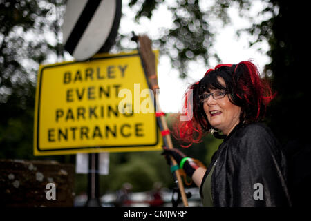 Lancashire, UK. Saturday, August 18th 2012.  Anne Anderson, 50, directing traffic at the Big Witch Event Barley, in the borough of Pendle, in Lancashire, England.  Official Guinness World Record attempt at “the largest gathering of people dressed as witches, raising funds for Pendleside Hospice on the occasion of the 400th anniversary of the Pendle Witch Trials Stock Photo