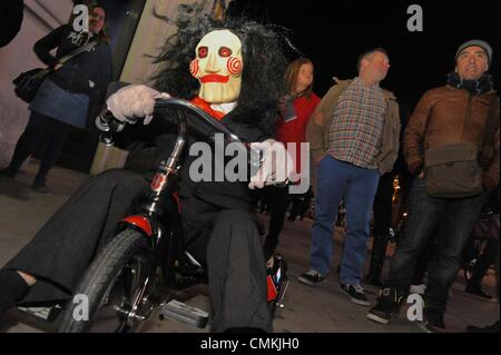 London, UK, UK. 3rd Nov, 2013. A performer rides a tricycle wearing a clown mask in front of The famous Piccadilly Institute which hosted it's annual Halloween costume ball Credit:  Gail Orenstein/ZUMAPRESS.com/Alamy Live News