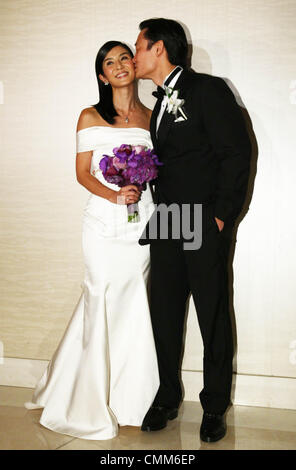 Charlie Yeung and husband Qiu Shaozhi pose for camera at their wedding ceremony in Singapore on Saturday November 2,2013. Stock Photo