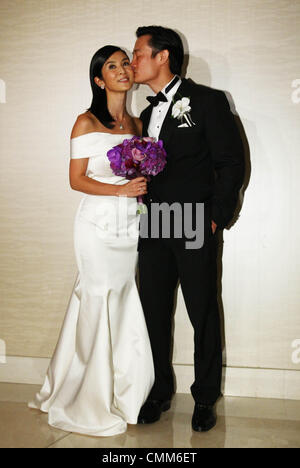 Charlie Yeung and husband Qiu Shaozhi pose for camera at their wedding ceremony in Singapore on Saturday November 2,2013. Stock Photo