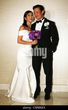 Charlie Yeung and husband Qiu Shaozhi pose for camera at their wedding ceremony in Singapore on Saturday November 2,2013. Stock Photo