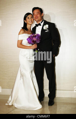 Charlie Yeung and husband Qiu Shaozhi pose for camera at their wedding ceremony in Singapore on Saturday November 2,2013. Stock Photo