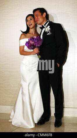 Charlie Yeung and husband Qiu Shaozhi pose for camera at their wedding ceremony in Singapore on Saturday November 2,2013. Stock Photo