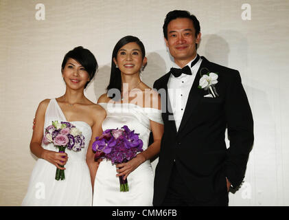 Charlie Yeung,husband Qiu Shaozhi and bridesmaid Valen Hsu pose for camera at their wedding ceremony in Singapore on Saturday November 2,2013. Stock Photo