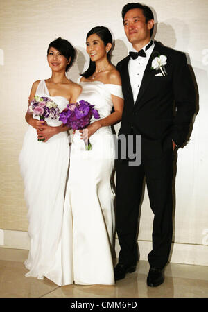 Charlie Yeung,husband Qiu Shaozhi and bridesmaid Valen Hsu pose for camera at their wedding ceremony in Singapore on Saturday November 2,2013. Stock Photo