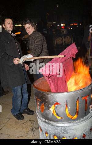 Anti-austerity protesters in Bristol are photographed burning a pair of red trousers to protest against Bristol's mayor George Ferguson who is well-known for his red trousers. Credit:  lynchpics/Alamy Live News