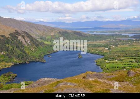 Glanmore Lake seen from the mountain road R572 which crosses the Caha Mountains at Healy Pass, photo taken May 30, 2013. The pass is at an altitude of just 300 metres, and yet the pass and the road winding downhill offer breath-taking views on Kenmare River and Iveragh Peninsula in the background. Photo: Frank Baumgart Stock Photo