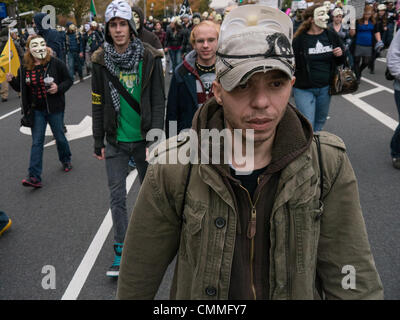 Washington, DC, USA. 05th Nov, 2013. Masked supporters of "Anonymous" marched from the White House to the U.S. capitol on Tuesday. They are seeking more transparency and less intrusion on privacy from the government and military. Credit:  Ann Little/Ģ����ý Live News Stock Photo