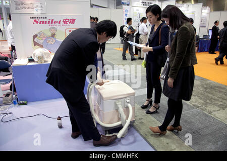 Tokyo, Japan. 6th Nov, 2013. Visitors see the automatic toilet 'Smilet' at the International Robot Exhibition 2013 in Tokyo, Japan, November 6, 2013. The IREX is the largest robot trade fair in the world and shows new robots and high technology equipments at theTokyo International Big Sight. The exhibitions runs from November 6 to 9. © Rodrigo Reyes Marin/AFLO/Alamy Live News Stock Photo