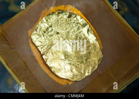 Gold leaf is gold that has been hammered into extremely thin sheets and is often used for gilding. Stock Photo