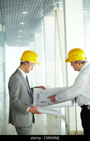 Two architects looking at a project and discussing it Stock Photo