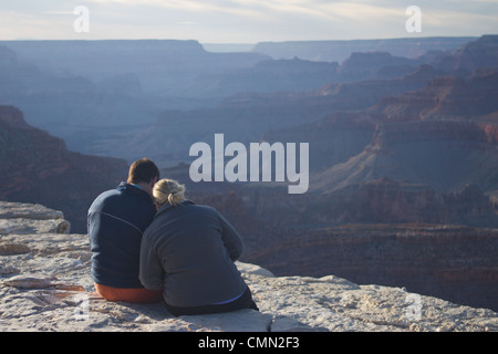Couple waiting for the sunset on the south rim of the Grand Canyon, Grand Canyon National Park, Arizona. Stock Photo