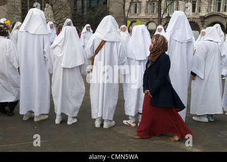 Muslim young woman UK, being photographed next to a Druids circle who perform Spring Equinox ceremony at Tower Hill London Multicultural London 2012 2010s England HOMER SYKES Stock Photo