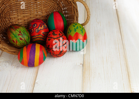 Six painted Easter eggs came out of the rattan basket Stock Photo
