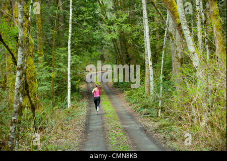 Mixed race runner training on remote road Stock Photo