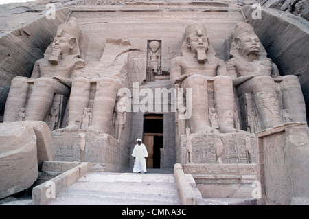 Four colossal statues of Ramesses II guard the entrance to his famous rock-cut temple at Abu Simbel built in Nubia, Egypt, to honor himself as pharaoh. Stock Photo