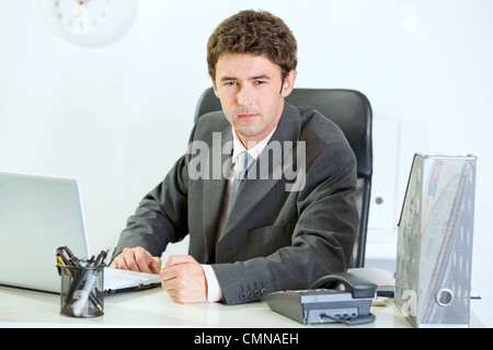 Angry modern businessman banging fist on table Stock Photo