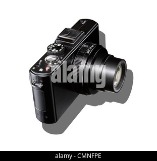 A black camera with shadow on a white background. Stock Photo