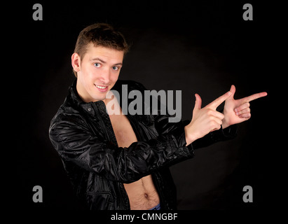 Handsome man looking to viewer and points something Stock Photo