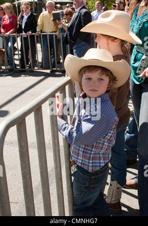 Young boy and young girl wearing cowboy hats at outdoor Texas Rodeo event Stock Photo