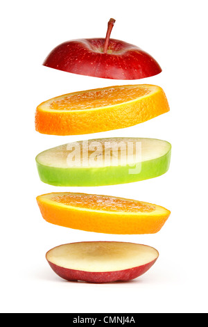 Levitating fresh sliced fruit, isolated on white Stock Photo