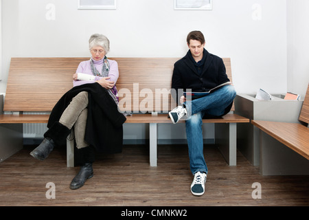 two people sitting in a general practitioner's waiting room Stock Photo