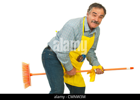 Funny cleaner mature man riding broom isolated on white background Stock Photo