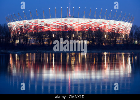 National Stadium in Warsaw illuminated at dusk, ready for the opening match of Euro 2012, reflection on the Vistula river Stock Photo