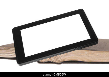 Digital tablet device, displaying white, leaning against old open book. Isolated on white. Stock Photo