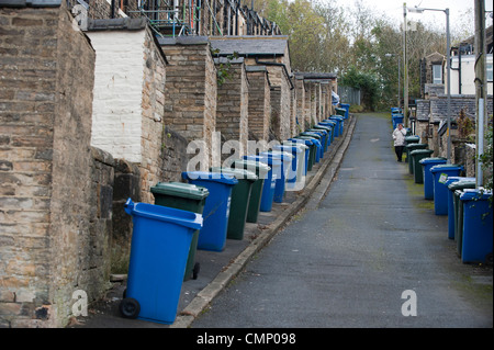 Wheelie bins lined up ready for collection in a steep cobbled back ...
