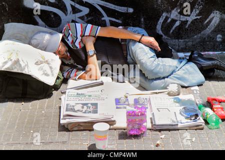 Santiago Chile,Providencia,Avenida Libertador Bernardo O'Higgins,street,sidewalk,Hispanic man men male adult adults,homeless,sleeping on street,newspa Stock Photo