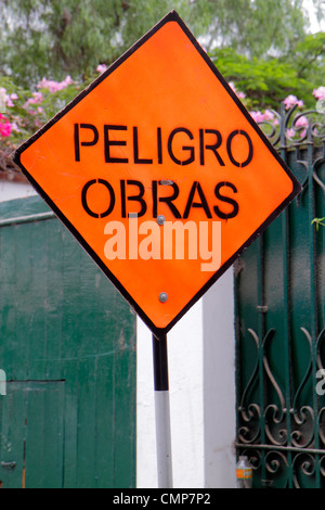Lima Peru,Barranco District,Calle 28 de Julio,street sign,warning,Spanish language,bilingual,peligro,danger,under new construction site building build Stock Photo