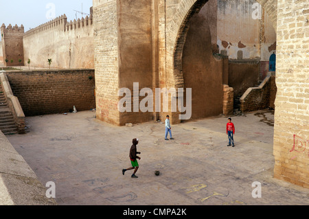 Rabat, Moroccan children playing football in one of the gates of the Medina, old town, Africa Stock Photo