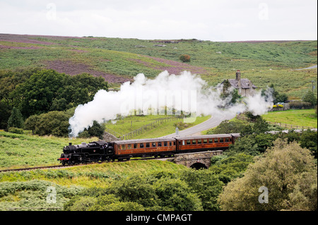 North Yorkshire Moors Railway. Vintage steam locomotive railway engine No.80072 pulls train south from Goathland, England, UK Stock Photo
