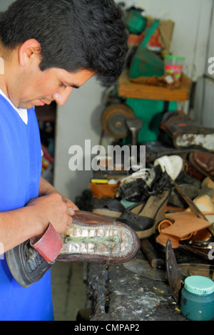 Lima Peru,Barranco,Avenida Pierola,shoe repair,cobbler,shop,Hispanic man men male adult adults,trade,tool,workbench,sole,working,work,Peru120117007