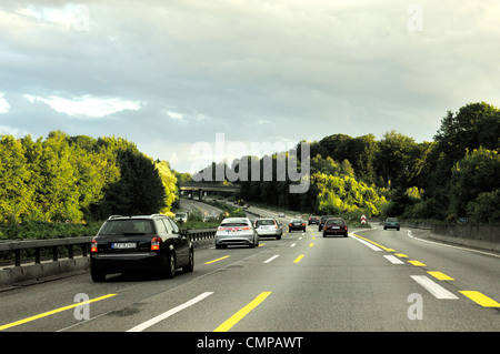 Driving on German autobahn motorway in Nordrhein-Westfalen. Turn off intersection near Dusseldorf. Evening light Stock Photo