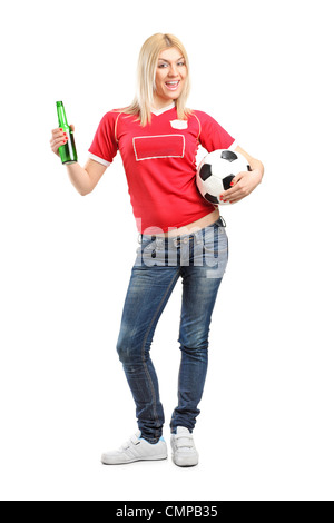 Full length portrait a blond female fan holding a beer bottle and football isolated on white background Stock Photo