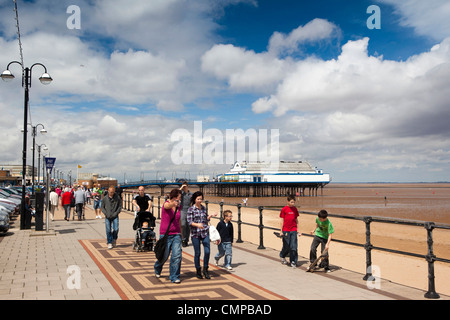 UK, England, Lincolnshire, Cleethorpes, visitors walking on promenade in summer sunshine Stock Photo
