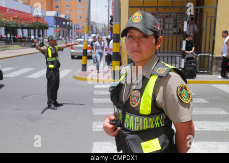 Tacna Peru,Calle San Martin,street scene,Hispanic man men male,woman female women,traffic,cop,police,Policia Nacional,law enforcement,uniform,crossing Stock Photo