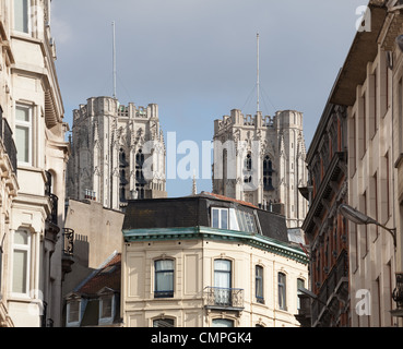 Towers of Cathedral of St Micheal in Brussels over top of local homes and roofs Stock Photo