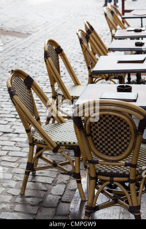 Row of empty restaurant tables and chairs of a street cafe in Belgium Europe close up