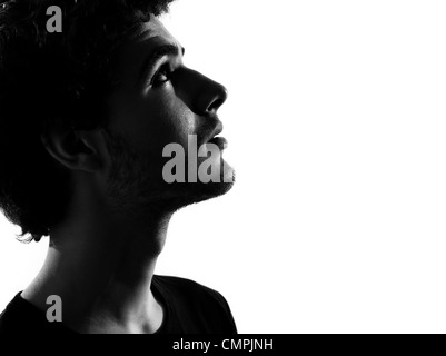 young man anxious looking up portrait silhouette in studio  isolated on white background Stock Photo