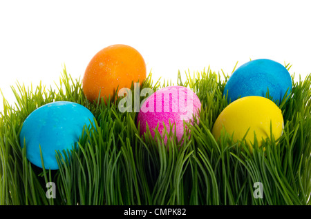 Five colorful dyed eggs in green grass Stock Photo
