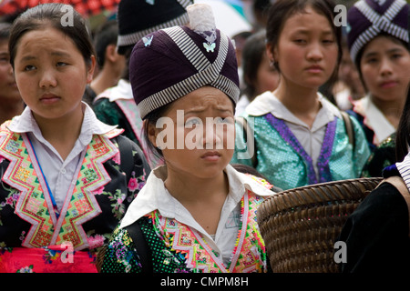 A group of Hmong women are marching in a parade on a city street during the Lao New Year celebration in Luang Prabang, Laos. Stock Photo